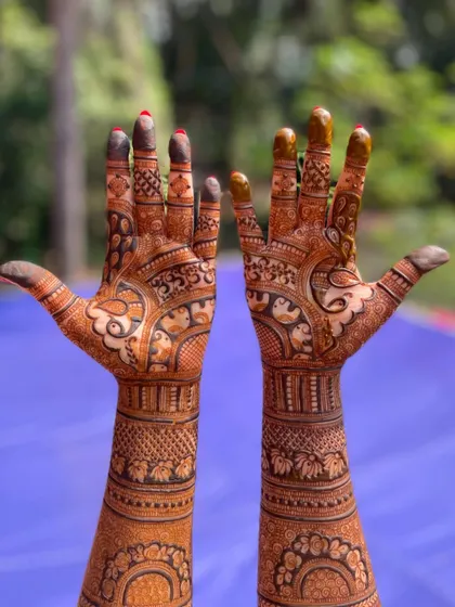 A classic full-arm bridal mehendi that showcases incredible detail from the fingertips to the elbows. I used a combination of fine lines, bold figures, and traditional patterns to create a rich and symmetrical look.