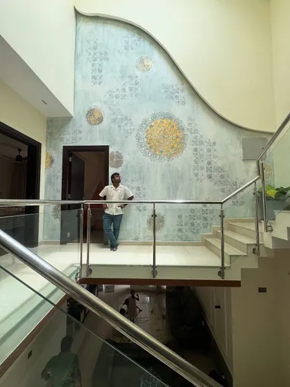 Here I am, standing on the landing in front of the completed large-scale abstract mural. It's moments like these, seeing the final vision come to life, that I live for.