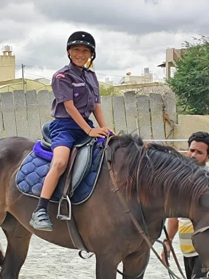 This student, part of our Scouts and Guides unit, looks confident and happy during her horse riding session.