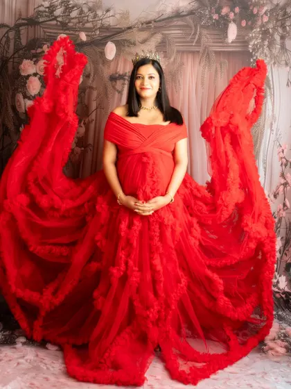 A powerful and dramatic portrait in a red gown with fabric tossed to look like wings. A true statement image.