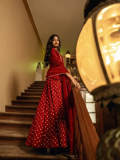 A dramatic portrait on a staircase, using warm lighting to create a cinematic and luxurious feel.