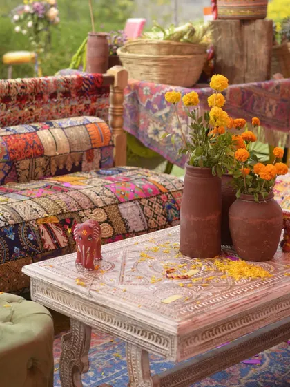 A cozy seating nook with rustic furniture and vibrant, traditional textiles, creating a warm and inviting atmosphere.