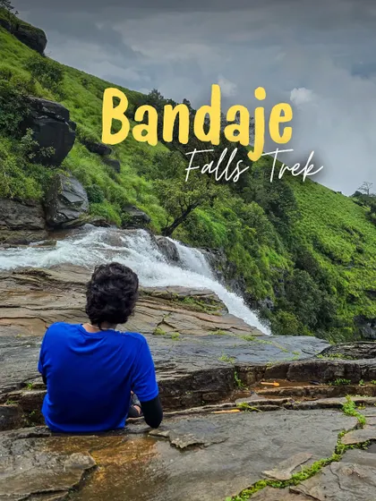 A trekker sits at the top of Bandaje Falls, taking in the incredible view of the water plunging into the valley.