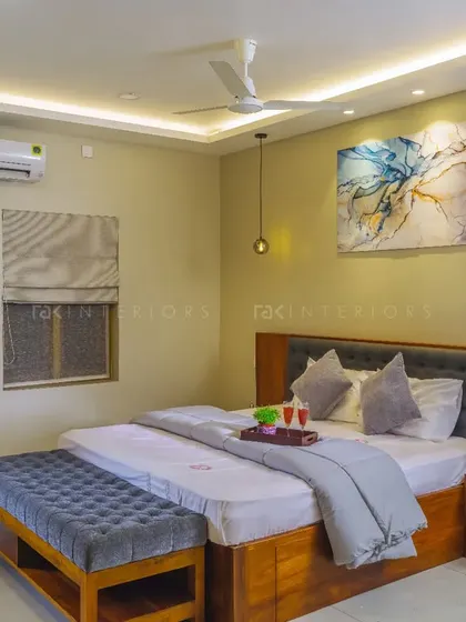 A pleasant bedroom design with light shades and a wooden bed, creating a relaxing place to come back to.