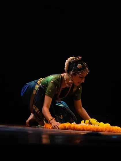 Using simple props like a garland of marigolds can add a powerful symbolic element. In this piece from 'Ananta', the flowers represent an offering, a connection to the divine.