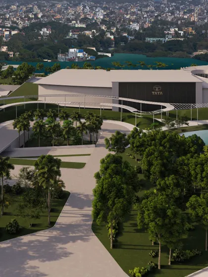 This rendering showcases a large corporate campus with a water feature. The design balances modern architecture with natural landscaping, creating a space that is both productive and pleasant for a major brand like Tata.