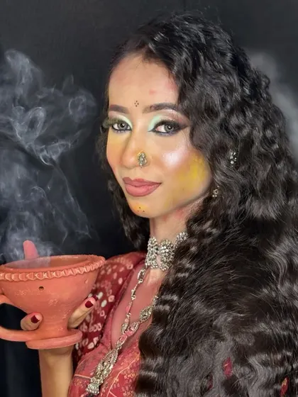 This shot with a smoking diya adds a traditional and atmospheric touch to the festive makeup.