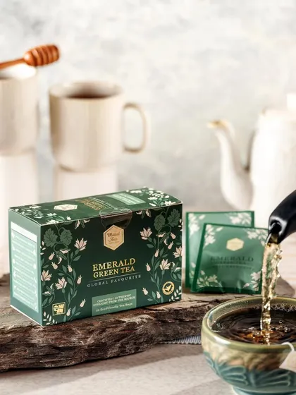 A bright and airy shot of Mittal's Emerald Green Tea being poured. The clean lighting and simple styling create a fresh and healthy vibe, perfect for a wellness-focused tea brand.