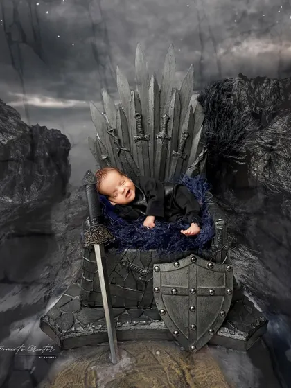 A smiling king on his throne. This Game of Thrones inspired portrait captures a rare and precious newborn smile.