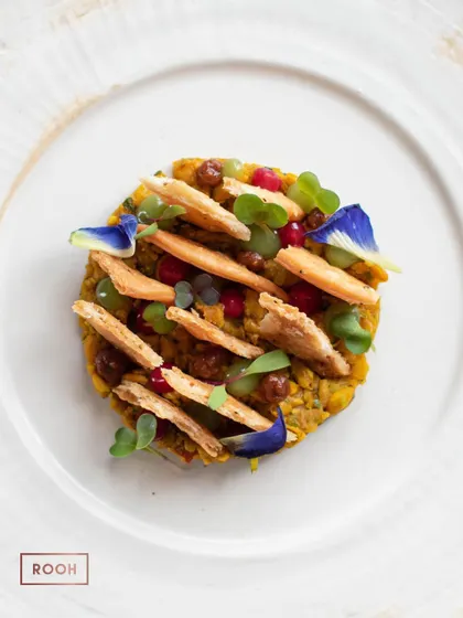 Every dish is a canvas. This is our Khasta Matar Chaat, a beautiful arrangement of textures and colors that reinterprets a classic street food dish with artistic flair and elevated flavors.