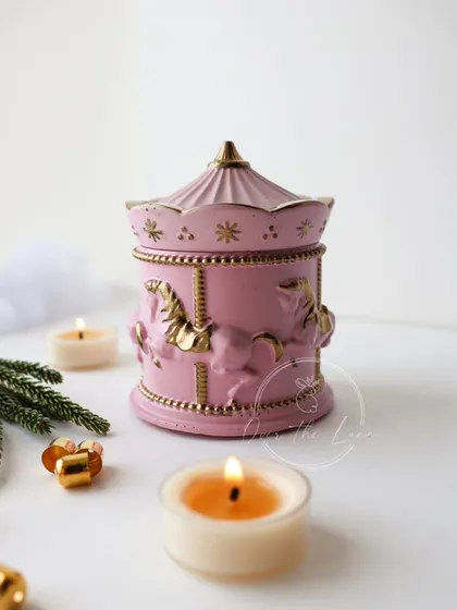 The pink merry-go-round jar is a whimsical and elegant decor piece.