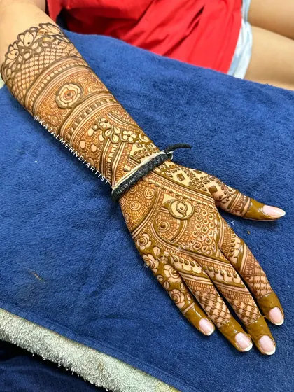 There is magic in every stroke of henna. This full-arm bridal design showcases a variety of patterns and textures, creating a stunning piece of wearable art.