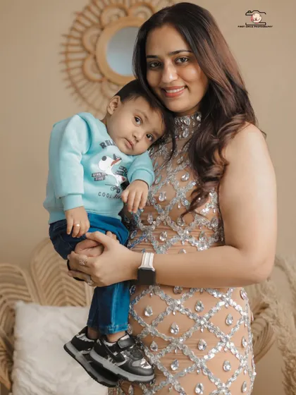 A tender moment between a mother and her son. He rests his head on her shoulder, a simple gesture of comfort and love, captured beautifully during their family studio session.
