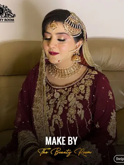 A beautiful shot of the bride, showcasing the complete look with her jewellery and outfit. The makeup is designed to enhance her features and match the rich tones of her dress.