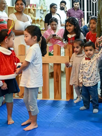 Children and parents mingle during the Christmas party. These events are a great opportunity for families to connect and build our school community.