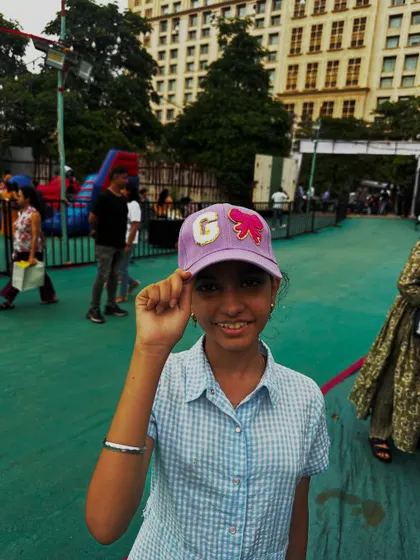 A happy customer wearing her new personalized cap at my pop-up stall.