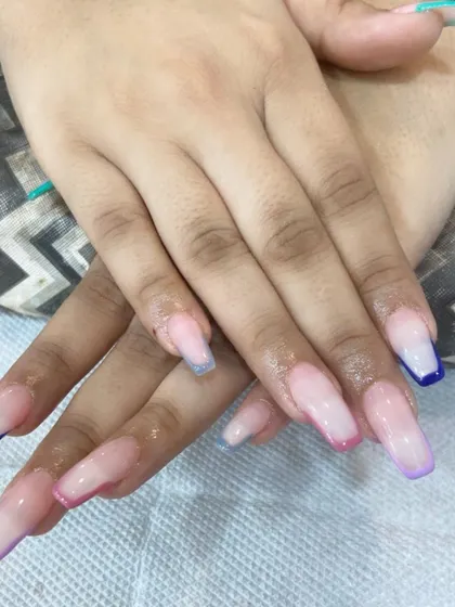 Here is another angle of the multi-color French tip extensions. This style is perfect for anyone who wants a subtle design that still shows off a bit of color and personality.