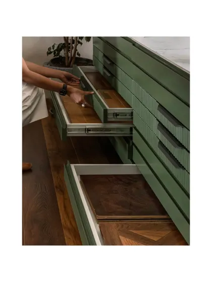 A close-up of the tiered sample drawers, revealing the intricate herringbone wood patterns within. This solution keeps the showroom organized and allows for an efficient, hands-on client experience.
