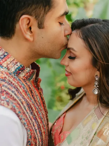 A tender forehead kiss during the Haldi photoshoot, a moment of quiet affection.