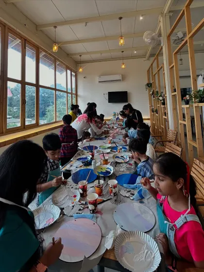 This long-table setup is perfect for larger groups, allowing everyone to work together and share the experience. You can see the variety of colors and ideas taking shape.