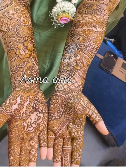 This is the fresh henna paste right after application. You can see the intricate details of the floral and geometric patterns. The final color will develop into a beautiful deep red-brown.
