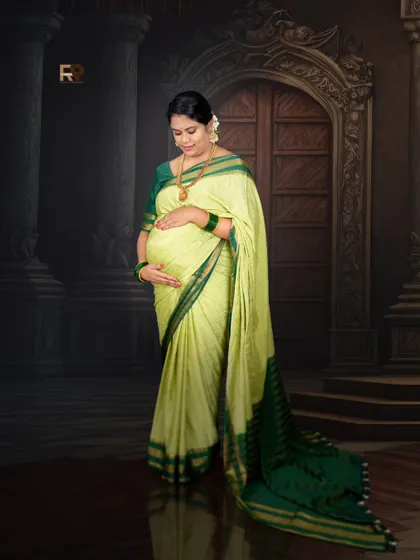 A simple yet powerful portrait. The dark, classic backdrop makes the light green saree stand out, with all the focus on the mom-to-be and her baby bump.
