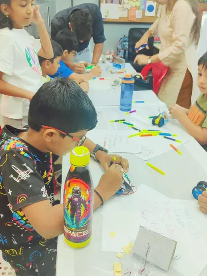 Another group of kids working on their projects, including a custom-designed Robo Car. They get to decorate and build their creations from scratch.