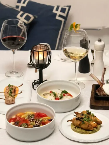 Another view of a table laden with our Mediterranean specialties, paired with both red and white wine to complement the different dishes.