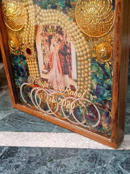 Another angle of the orchid and ornament wedding frame. The depth of the frame allows for a beautiful 3D arrangement of the couple's most precious wedding day items.
