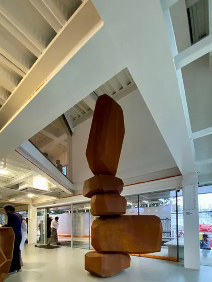 A towering sculpture by artist Arik Levy commands the atrium space at MAP. The architecture was designed to accommodate such large, impactful pieces, creating dramatic vertical views through the different levels of the museum.