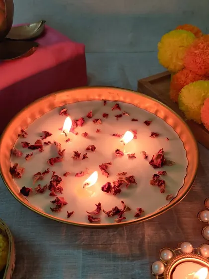 Our rose petal candle bowl, lit and glowing. The gentle scent of rose fills the air, creating a serene, festive atmosphere.