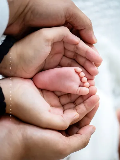Held safe and sound in your hands. This classic newborn shot of tiny feet cupped by loving parents is a powerful reminder of how small they once were.