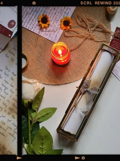 The ambient glow of a candle highlights the beauty of a finished scroll letter in its glass box, a perfect scene for a romantic gift.