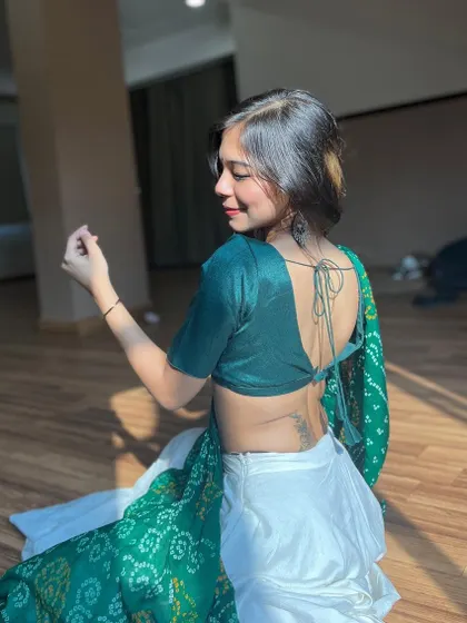 A back profile shot showcasing the elegant design of the blouse and my posture.
