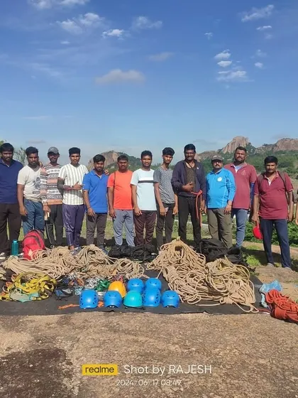 The group proudly displays their climbing equipment after a session on anchoring techniques.
