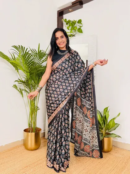 This black printed satin saree is a classic choice for the office. The geometric print is modern and chic, and it can easily transition from a day meeting to an evening dinner.