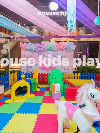 The rainbow play area featuring a white rocking unicorn, a fun addition to our colorful setup.