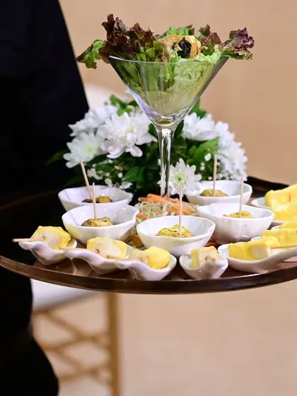 A tray of assorted passed appetizers, including salad martinis and paneer skewers. Our servers ensure that every guest gets to sample these delightful bites.