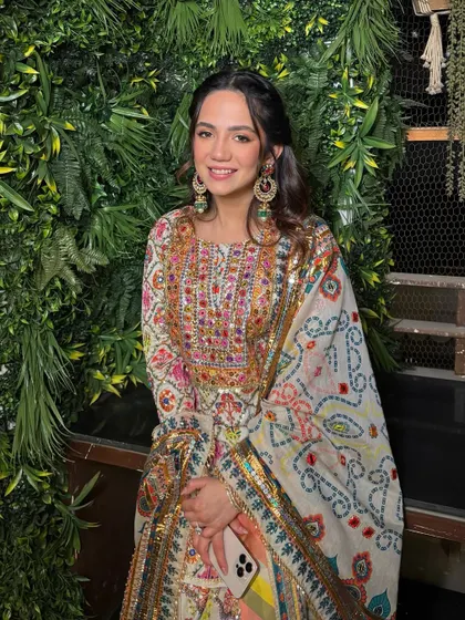 The full look, showing how her colorful outfit is perfectly balanced with fresh, glowing makeup that lets her personality shine.