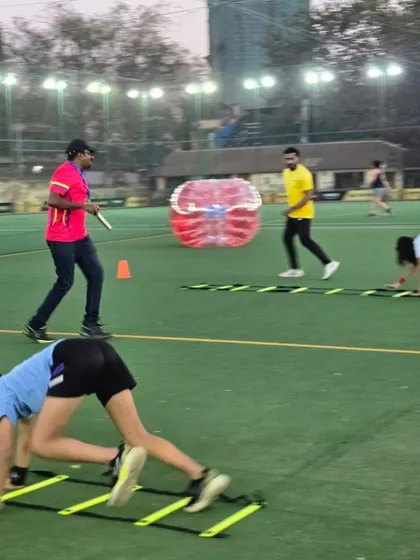 A full view of our turf setup in action. You can see kids engaged in various activities, from ladder drills to Zorb ball fun, all under the watchful eye of our coaches.