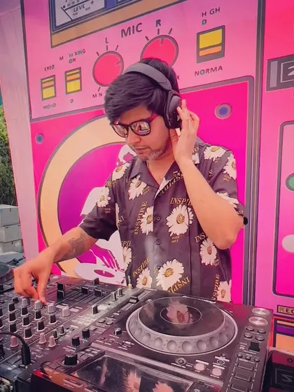 In the zone at a daytime event. The right music can make any setting feel special, and I'm focused on finding that perfect track.