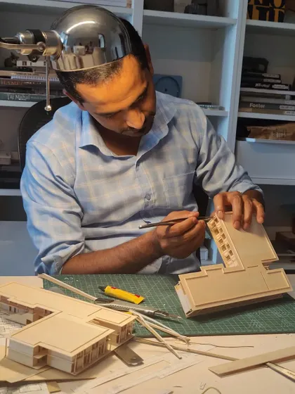 The hands of our master model maker, Vijay, meticulously crafting a detail. Physical models are a critical tool for us to study scale, proportion, and the play of light before construction begins.