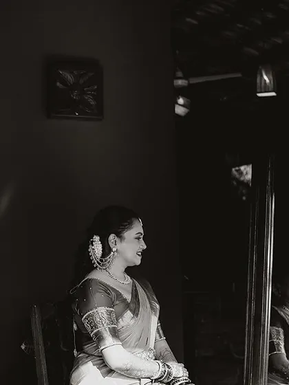 A bride, seen in reflection, a quiet and artistic shot that captures a moment of introspection.