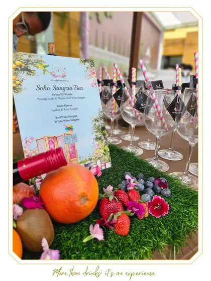 The Soho Sangria Bar, a vibrant and fresh concept for any celebration. The bar is decorated with an abundance of fresh fruits and flowers, creating a beautiful and delicious experience.