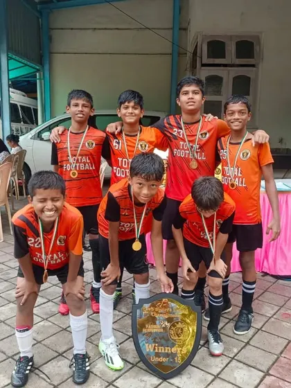 The U15 champions posing with their trophy at the 5v5 Sports tournament.