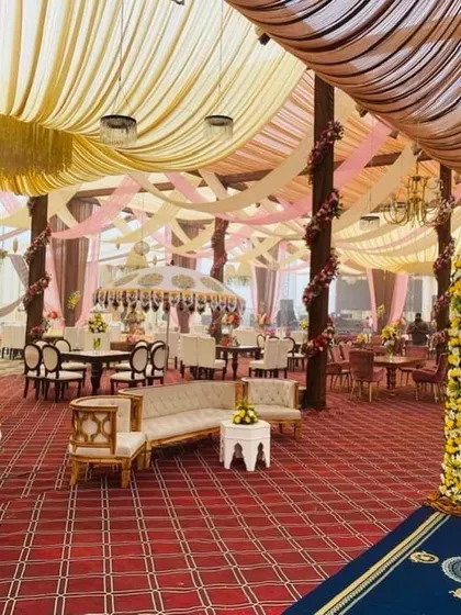 A view of the indoor seating and decor from the entrance. The draped ceilings and floral-wrapped pillars show how we carry the decorative theme throughout the entire venue for a cohesive look.