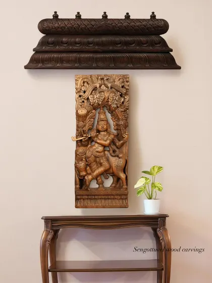 A wall display featuring a carved wooden bracket and a panel depicting Lord Krishna, showcasing how our different pieces can be curated together.
