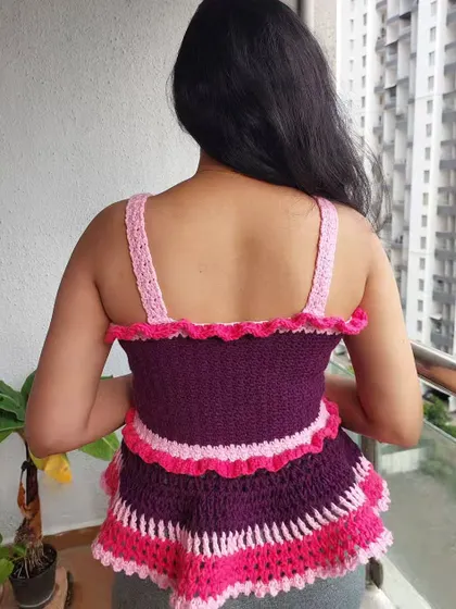 A view from the back of the Azores Top, highlighting the simple straps and ruffled neckline.