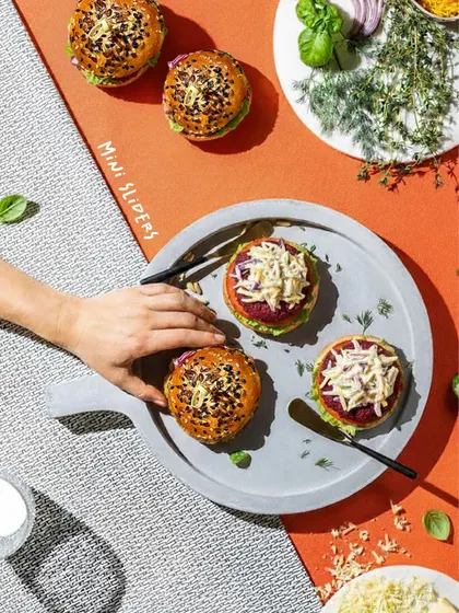 My mini sliders are always a crowd-pleaser. I use freshly baked, seeded buns and fill them with crisp vegetables, a secret sauce, and our earthy, homemade vegetarian patties. They are designed to be an irresistible gourmet experience.