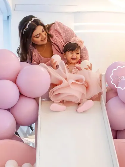A precious moment captured as the birthday girl, Aahana, enjoys the slide in her custom pink ball pit.